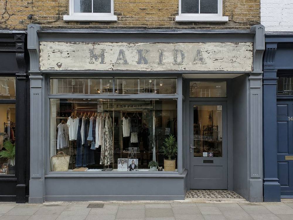 Shopfront before: faded, peeling sign